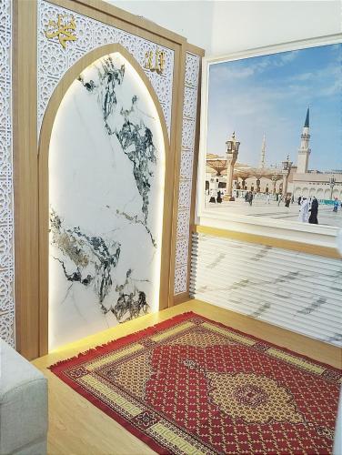 a room with a large window and a persian rug at Yasmine Homestay Rejodani in Ngaglik