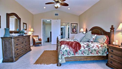 a bedroom with a bed and a dresser and a mirror at 403 Mariners Club in Key Largo