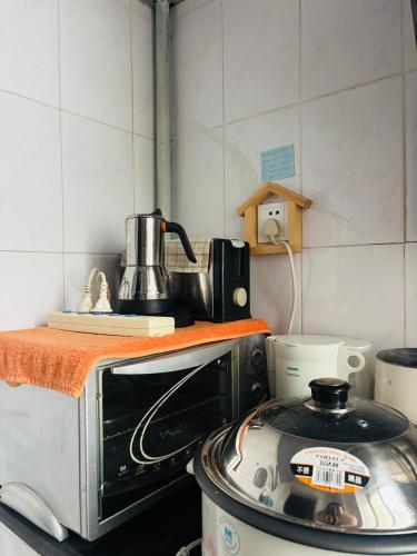 a kitchen with a stove and a toaster oven at Books&Bed Close to the Lake in Hangzhou
