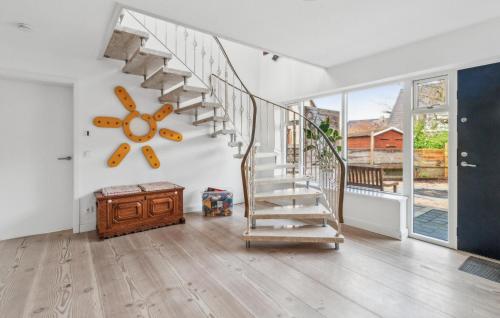 a living room with a spiral staircase in a house at Haus Hilda in Grömitz