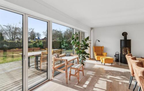 a living room with sliding glass doors and a table and chairs at Haus Hilda in Grömitz