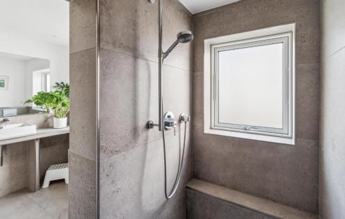 a shower stall in a bathroom with a window at Haus Hilda in Grömitz