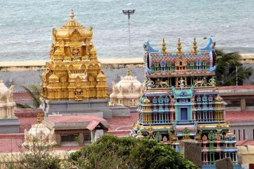a group of buildings in front of the ocean at Tamizh Nest - தமிழ்க்குடில் in Kanyakumari