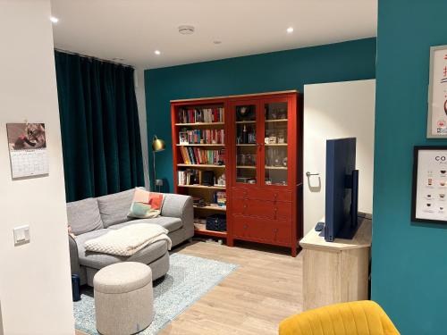 a living room with a couch and a tv at Flat in Hackney Wick in London