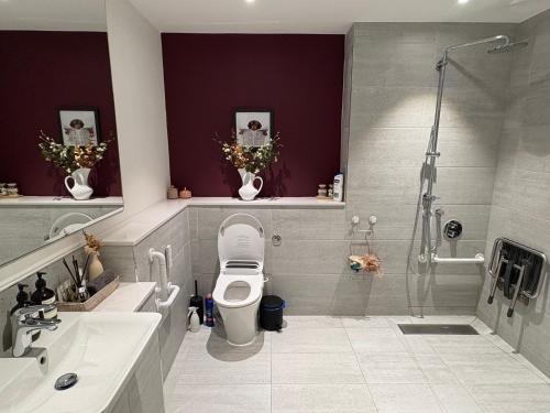 a bathroom with a shower and a toilet and a sink at Flat in Hackney Wick in London