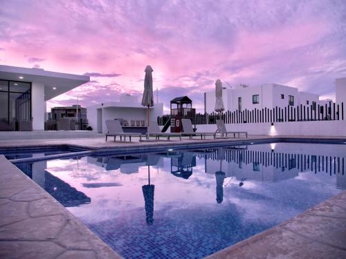 a house with a swimming pool in front of a building at Casa Diego in La Paz