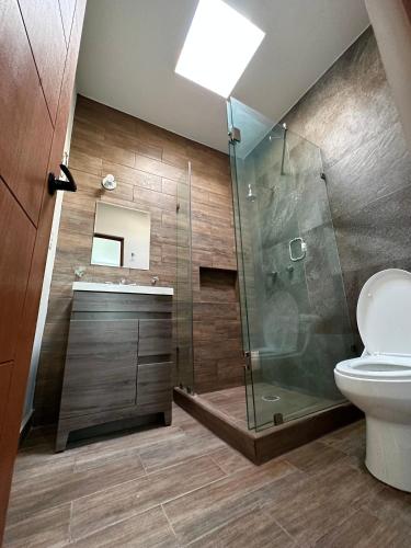a bathroom with a shower and a toilet at Casa Diego in La Paz