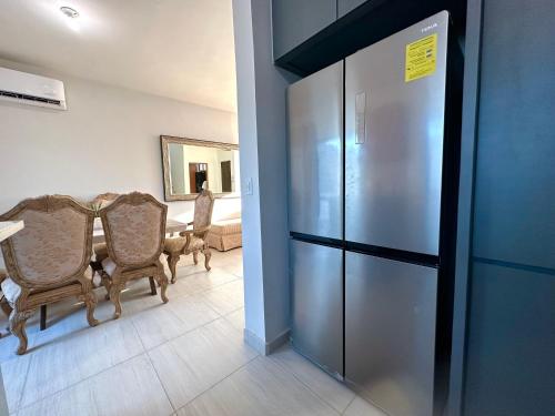 a dining room with a table and a refrigerator at Casa Diego in La Paz
