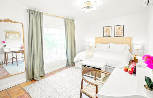 a bedroom with a bed and a desk and a window at The Mary Anne Boutique Hotel USVI in Charlotte Amalie