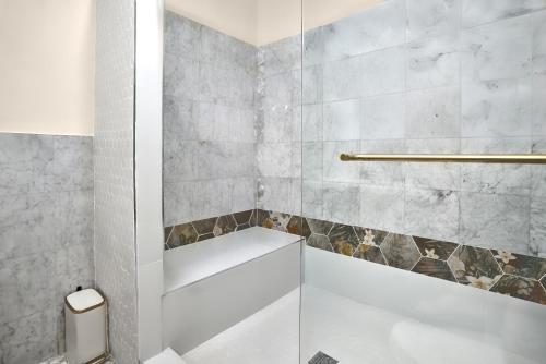 a bathroom with a tub and a shower stall at The Mary Anne Boutique Hotel USVI in Charlotte Amalie