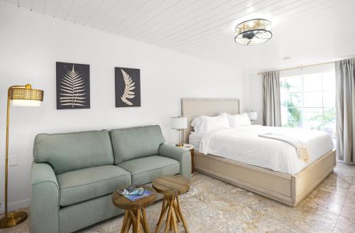 a bedroom with a bed and a couch at The Mary Anne Boutique Hotel USVI in Charlotte Amalie