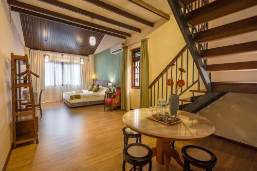 a living room with a table and chairs and a bed at Penang Story LINN House in George Town