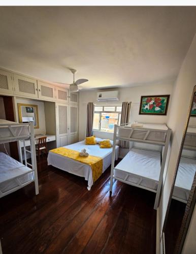 a bedroom with two bunk beds in a room at Pousada Rota do Sol in Cabo Frio