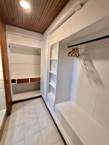 a walk in closet with a glass door at Casa Fama in San Andrés