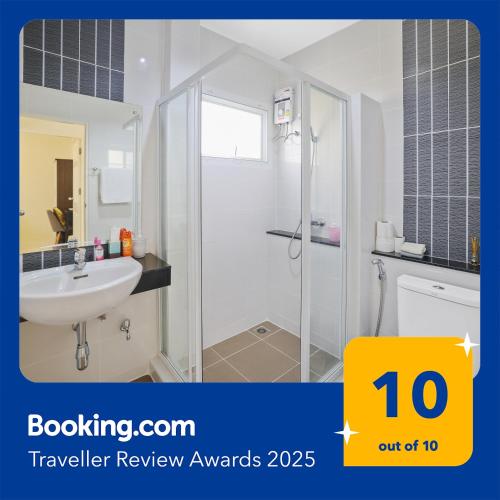 a white bathroom with a shower and a sink at Spacious Family Garden Villa - Huge Pool & Gym Access in Thalang