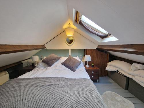 a bedroom with a large bed in a attic at Quarry Cottage in Blaenau-Ffestiniog