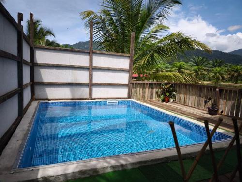 a swimming pool on the side of a building at Belibis Yard in Kampar