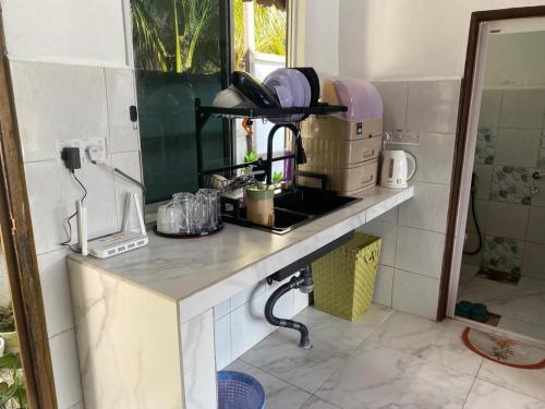 a kitchen with a sink and a counter top at Belibis Yard in Kampar
