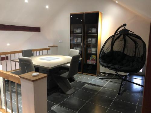 a dining room with a table and chairs at Cozy 120m Apartment with 3 Bedrooms and 1 Cinema in Useldange