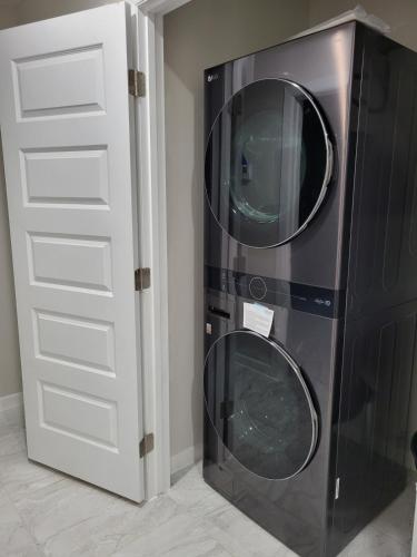 a washer and dryer next to a white door at Serene Mission Oasis! in Mission