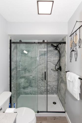a shower with a glass door in a bathroom at NEW! Remodeled & Upgraded Vacation Apartment in Sandusky