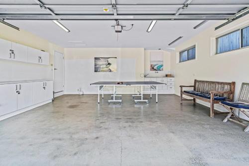 an empty room with a table and benches in it at Riverleigh, Gerroa in Gerroa