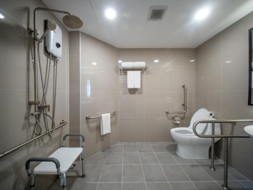 a bathroom with a toilet and a sink at Samutprakarn Hotel in Samut Prakan