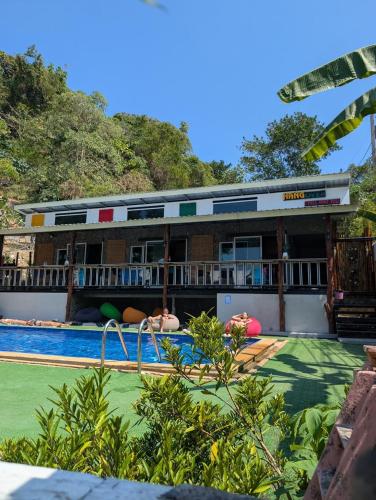 a pool at a resort with people swimming at Hangover Chill & Hill Hostel in Phi Phi Don