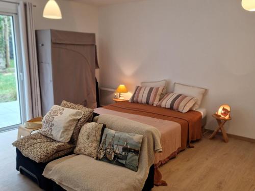 a bedroom with a bed and a couch and a chair at Studio neuf avec terrasse au cœur de Le Palais - FR-1-418-260 in Le Palais