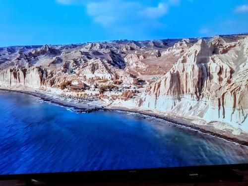 an aerial view of a mountain and the ocean at Hotel Pleasure Black Beach Perissa Santorini in Perissa