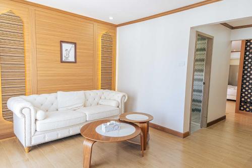 a living room with a white couch and a table at V.I.P BOUTIQUE HOTEL in Vientiane