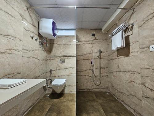 a bathroom with a shower and a toilet and a sink at 4BHK Penthouse Near Amer Fort-5 mins to Jal Mahal in Jaipur