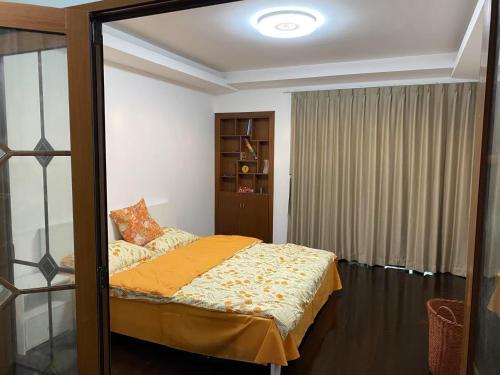 a bedroom with a bed with a mirror in it at Huinan Accommodation, Close to Airport, Disney Resort, Wild Animal Park, Near Metrol 16 in Shanghai