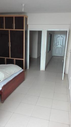 an empty room with a bed and a hallway at Kashmir Continental Hotel Murree in Murree