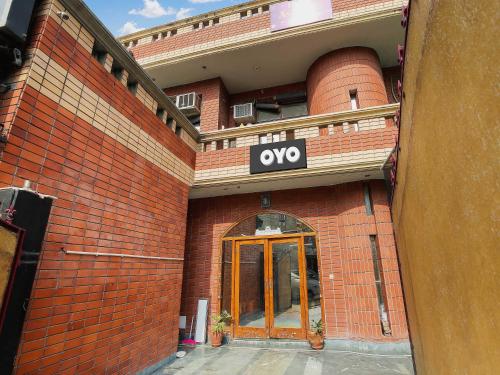 a brick building with an open sign on it at Hotel O Behl Ashiana in Amritsar