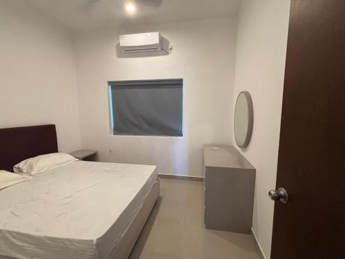 a bedroom with a bed and a mirror and a sink at Canterbury Golf Apartment in Gonapola