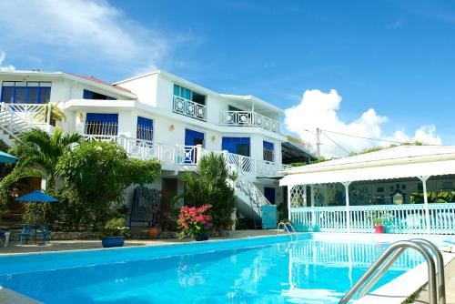 un hôtel avec une piscine en face d'un bâtiment dans l'établissement Hotel Cap Sud Caraibes, au Gosier