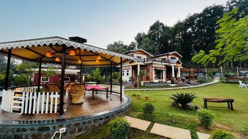 a house with a gazebo in a yard at Vanhills - Luxury Home Stay in Jim Corbett in Kota Bāgh