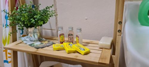 a shelf with two bottles of toothpaste and a vase of flowers at Tauraatini House F4 - PAPEETE in Papeete