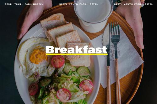 a plate of breakfast food with eggs and toast at Xi'an Desti Youth Park Hostel Bell & Drum Tower in Xi'an
