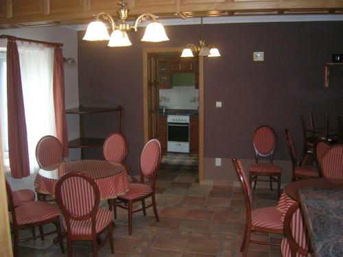 a dining room with a table and chairs and a kitchen at Balatoni Panoráma Villa in Balatonalmádi