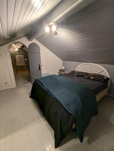 a bedroom with a large bed in a room at Maison atypique 5 couchages ,2 lits doubles et un lit simple ! avec un grand terrain !animaux bienvenus !wifi netflix écran plat 4k in Les Forges
