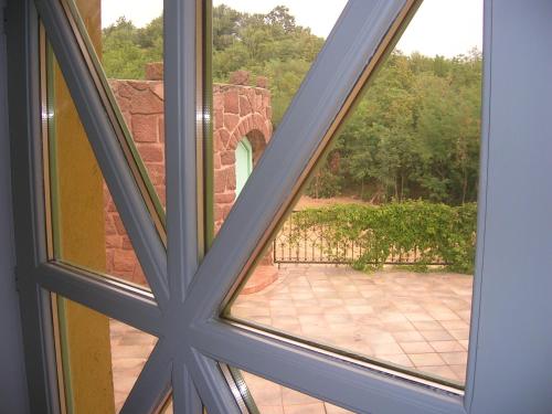 an open window with a view of a patio at Balatoni Panoráma Villa in Balatonalmádi
