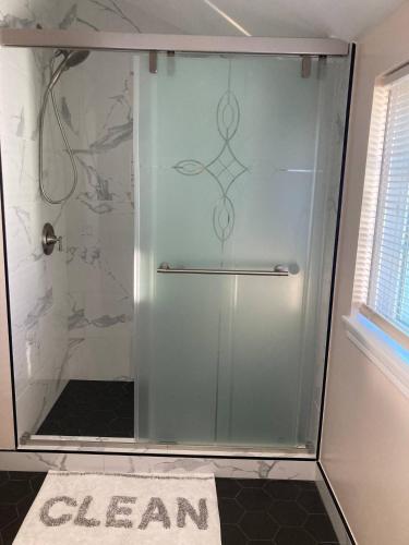 a shower with a glass door in a bathroom at Spacious bright room in Prime Silicon valley location in East Palo Alto