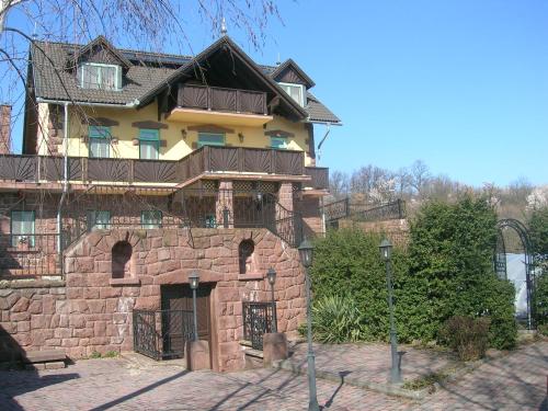 a large brick building with a balcony on top of it at Balatoni Panoráma Villa in Balatonalmádi