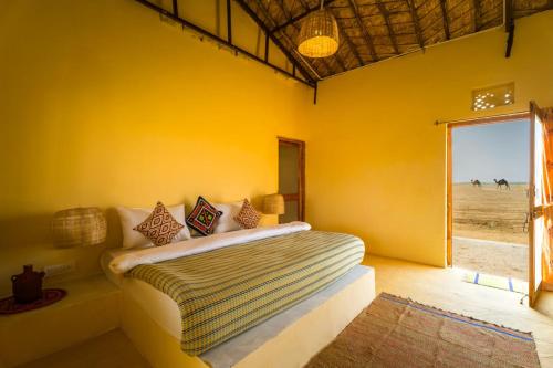 a bedroom with a bed in a room with a window at Vijay Bagh in Jaisalmer