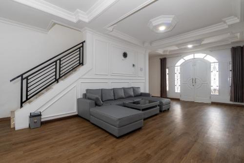 a large living room with a couch and a staircase at Villa Fiorenza II in Sampal 2