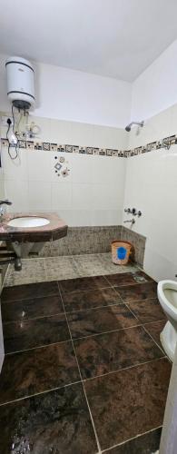 a bathroom with a toilet and a sink at Prashanth kuteer in Hyderabad