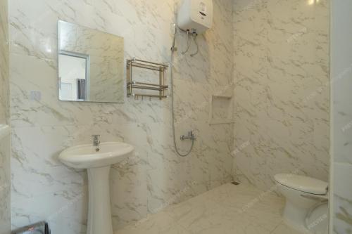 a white bathroom with a sink and a toilet at Villa Fiorenza II in Sampal 2