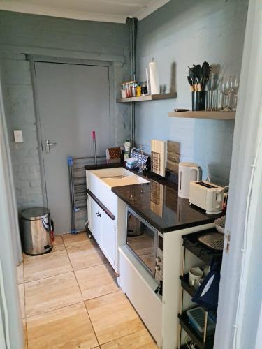 a kitchen with a sink and a counter top at H & E Sunset Paradise in Fisherhaven